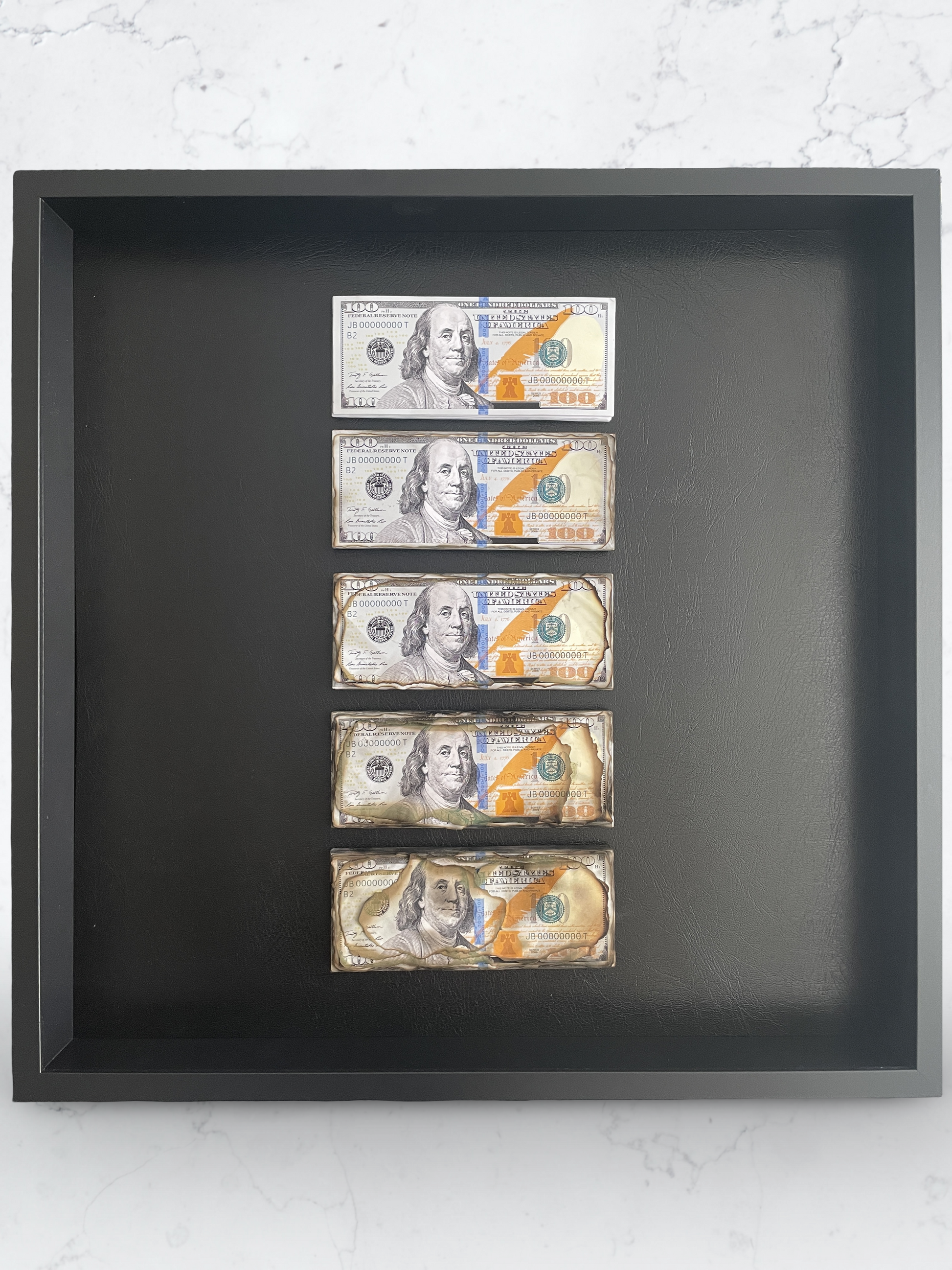 Stacks of U.S. dollar bills on a dark tray with a blurred background