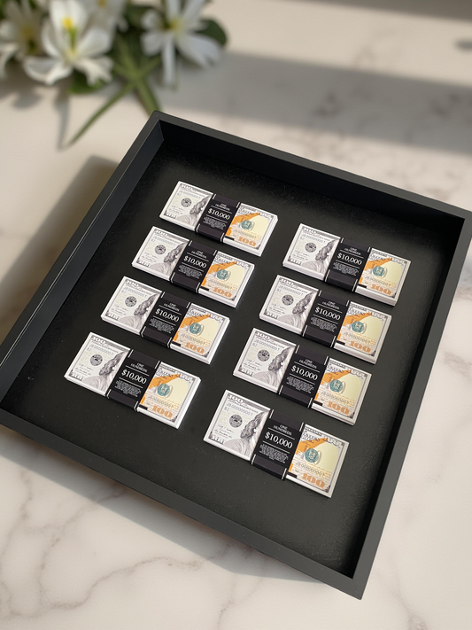 A collection of eight stacks of USD in a black shadowbox, placed on a marble surface.